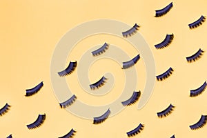 Several pairs of different false eyelashes on a yellow