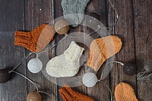 Several pairs of handmade baby socks on wooden background