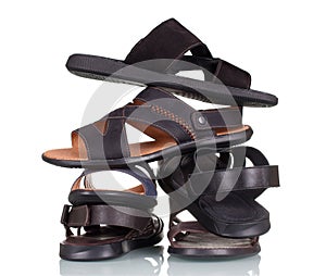 Several pairs of male shoes in a stack isolated on white