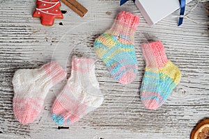 Several pairs of small woolen socks for newborn on wooden vintage table