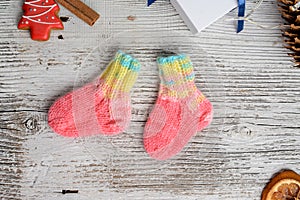 Several pairs of small woolen socks for newborn on wooden vintage table