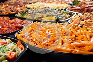 several pasta trays, penne