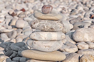 Several pebble stone on beach complex like symbol for zen