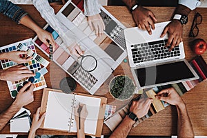 Several People. Desk. Vase and Notebook. Table.