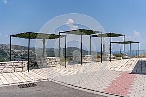 Several pergolas with table and chairs