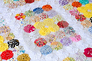 Several pieces of Fuxico sewn together forming a bedspread.