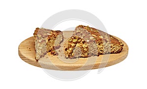 several pieces of homemade sponge cake with nuts on a wooden cutting board