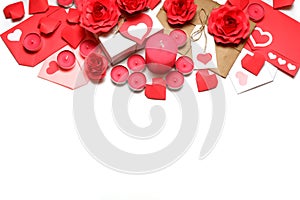 Several pink wax candles, gifts, love letters, 3D handmade red paper roses and hearts on white background. Love, Valentine`s,
