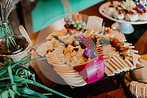 several plates of food displayed on wooden tables in the dining room