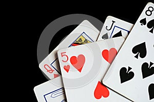 Several playing cards on a dark background c