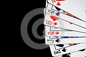 Several playing cards on a dark background c