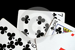 Several playing cards on a dark background c