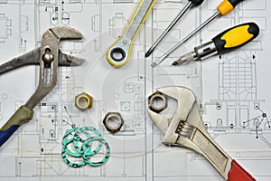 Plumber`s tools on an architectural plan of a house photo