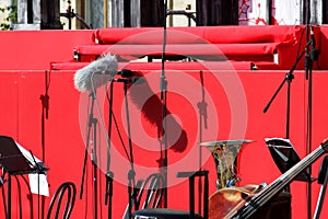 Several professional microphones on the stands stand near the stage before the performance of the orchestra. reportage photography