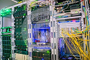 Several racks with telecommunication equipment are in the data center server room. The central technical platform of the Internet