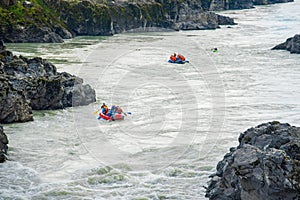 Several rafts and kayaks rafting on the mountain river Katun.