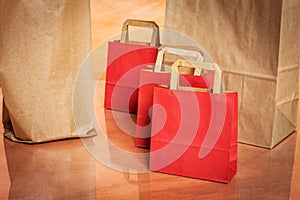 Several red and brown shopping bags