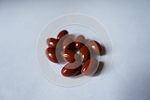 Several red capsules of lutein dietary supplement