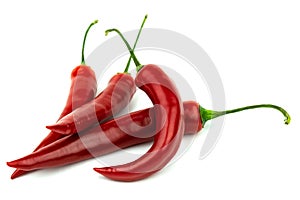 Several red hot peppers on a white background