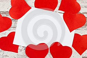 Several red Love hearts on white-painted wooden texture backgrou