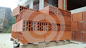 Several red perforated brick on pallet