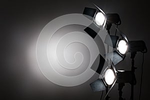 Several reflectors on the black background in photo studio.