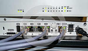 Several RJ45 LAN cables connected to wifi router formed communication network