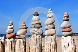 Several Rock zen pyramids of colorful pebbles on a beach on the background of the sea. Concept of balance, harmony and meditation