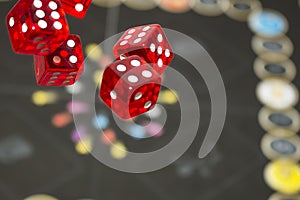 Several rolling red dice fall on a table with boardgame. Gameplay moments