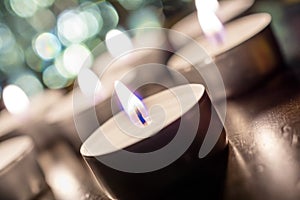 Several Romantic Candlelights At Night On Wooden Table With Bokeh And Crooked Angle