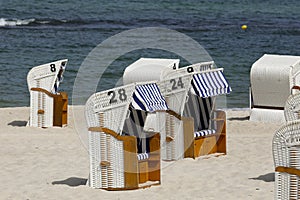 Several roofed wicker beach chairs