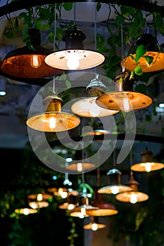 Several round loft style suspended luminaires with edison lamps shine a warm light. photo