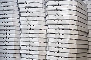 Several rows of pizza boxes, white pizza packing containers