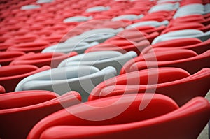 Several rows of red and white stadium seats