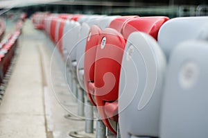 Several rows of red and white stadium seats