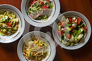 Several salads with vegetables and greens. Healthy food concept. Mixed vegetables