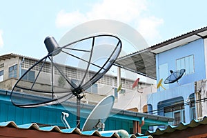 Several satellite dishes on building roof