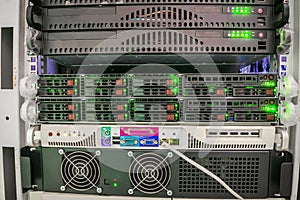 Several servers are located in the server room of the datacenter. Powerful Internet provider equipment. Front panel of central