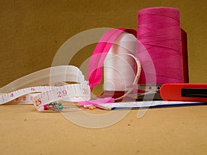 Several sewing items on a neutral yellow background