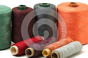 Several sewing spools of various color on white background, isolated