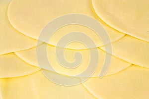 Several slices of provolone cheese photo