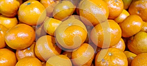 Several stacked fresh oranges