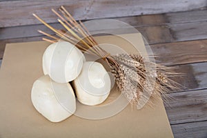 Several steamed buns and a handful of golden wheat ears