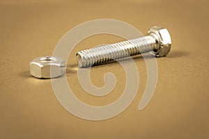 Several steel bolts and nuts on a light background. Close-up