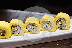 Several Tamago makizushi on plate. Japanese sushi