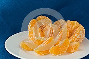 Several tangerines on white plate