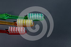 several toothbrushes on a black background.