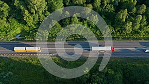 Several trucks and a semi-truck on a regional road. The concept of delivery of perishable goods, food products