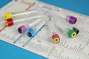 Several tubes for blood samples on test request sheet