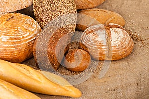Several types of bread on burlap background
